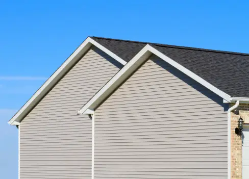 A close up of two houses with white trim